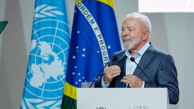 Presidente Luiz Inácio Lula da Silva discursa na COP30, em Belém, diante das bandeiras do Brasil e da ONU, destacando a importância da Amazônia para o clima global.